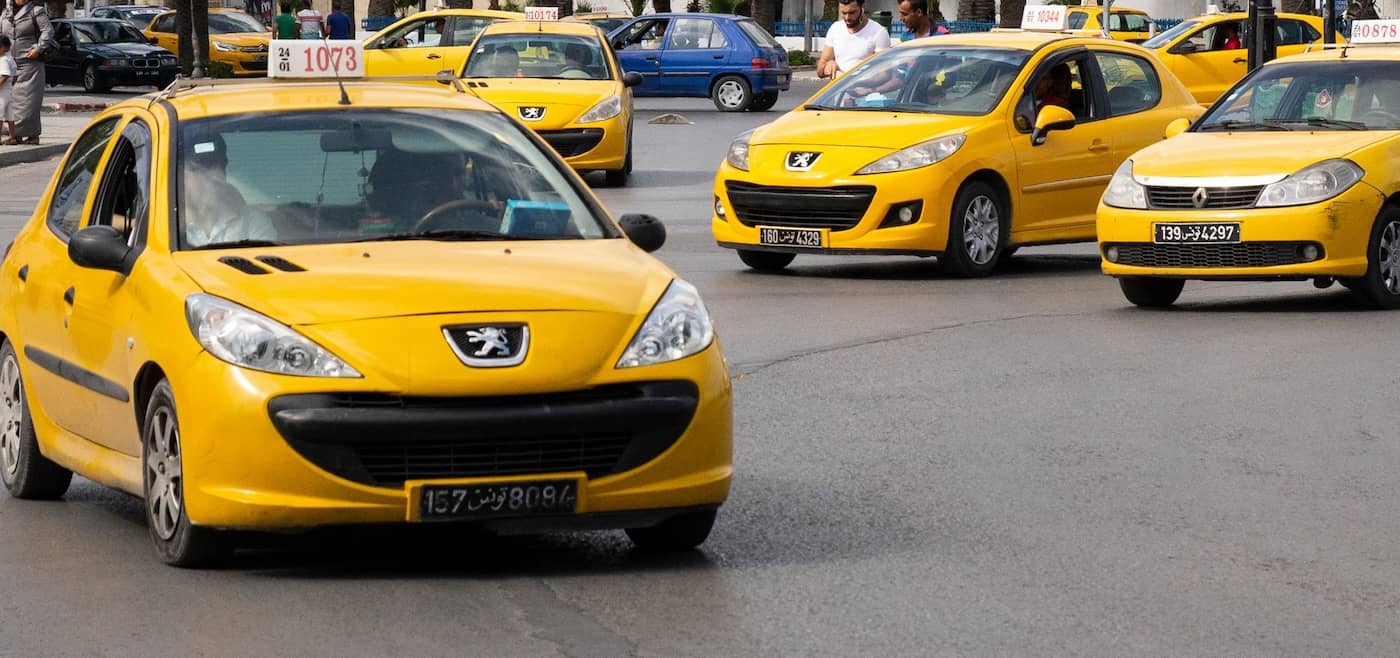Yellow taxi cab on a Tunisia city street - affordable local transportation